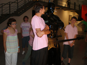 Midiendo una de las esculturas comparando a uno de los jóvenes más altos.